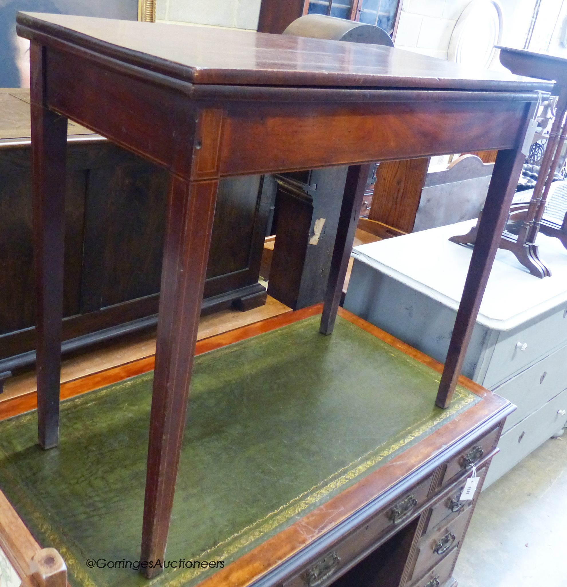 A George III rectangular mahogany folding tea table. W-91cm, D-45cm, H-79cm.
